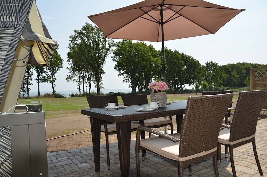 Ihre Terrasse mit Gartenmöbeln, Sonnenschirm, Strandkorb und tollem Blick aufs Meer.