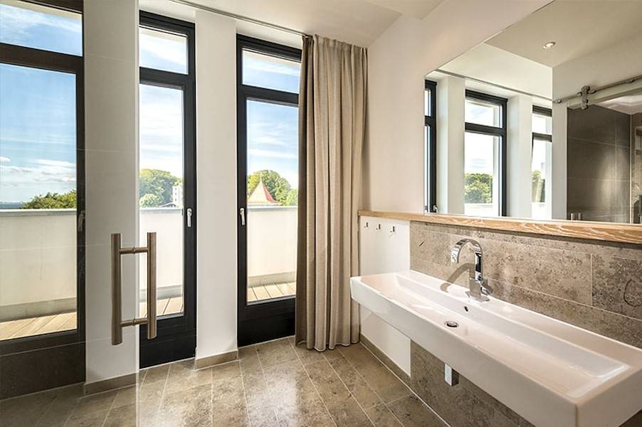 Das moderne Bad mit Ausgang zur Terrasse