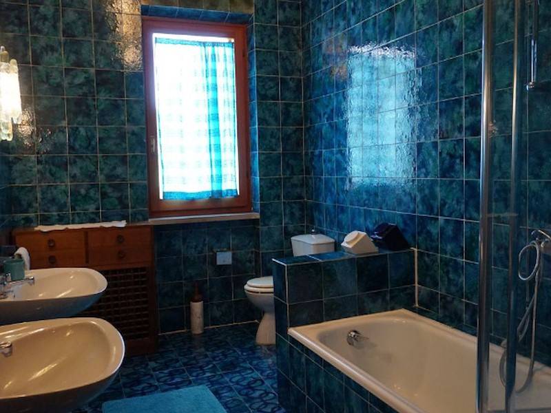 Ein Badezimmer mit Doppelwaschbecken und Badewanne mit  Duschmöglichkeit.